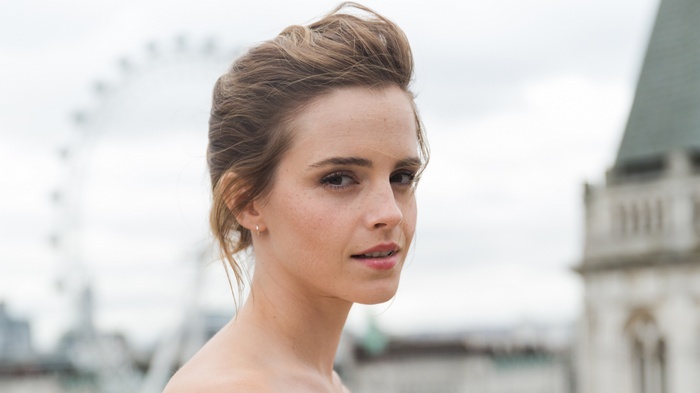 Emma Watson posing outdoors with London Eye in background