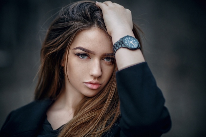 Portrait of a young woman with a watch