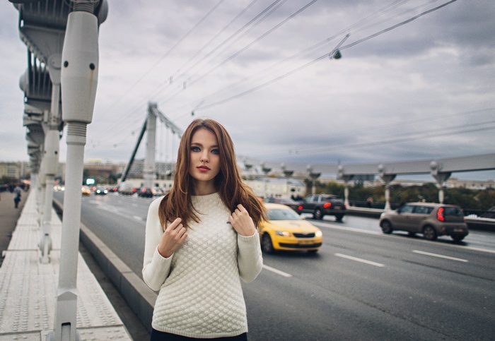 Woman on a bridge with traffic