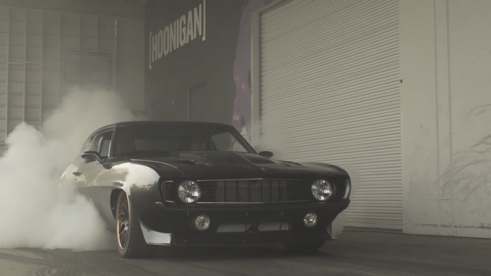 Black Hoonigan Chevrolet Camaro doing a burnout