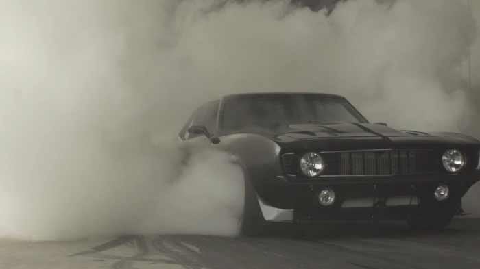 Black Chevrolet Camaro performing a burnout