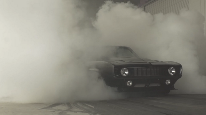 Black Chevrolet Camaro performing a burnout
