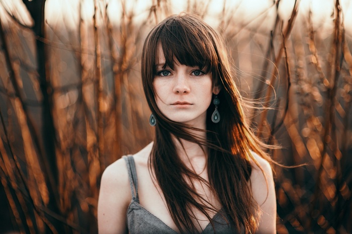 Woman with long auburn hair and blue eyes