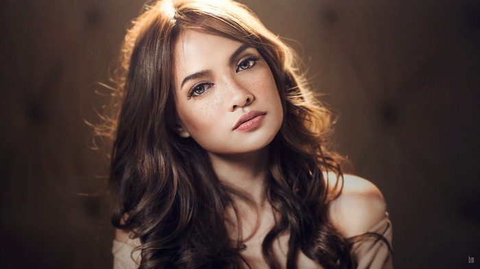 Woman with freckles and wavy brown hair