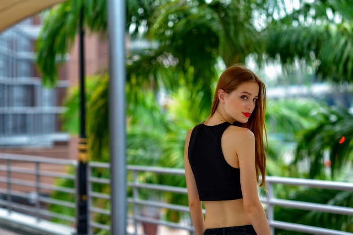 Woman with red hair wearing a black crop top