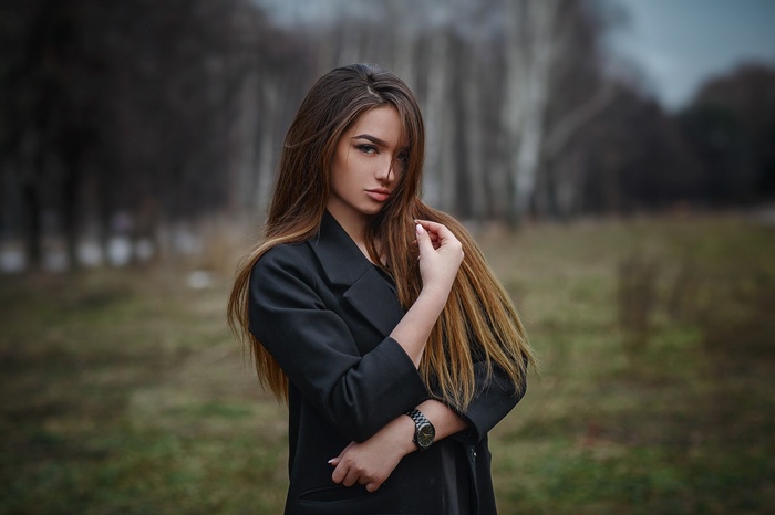 Woman in black coat outdoors