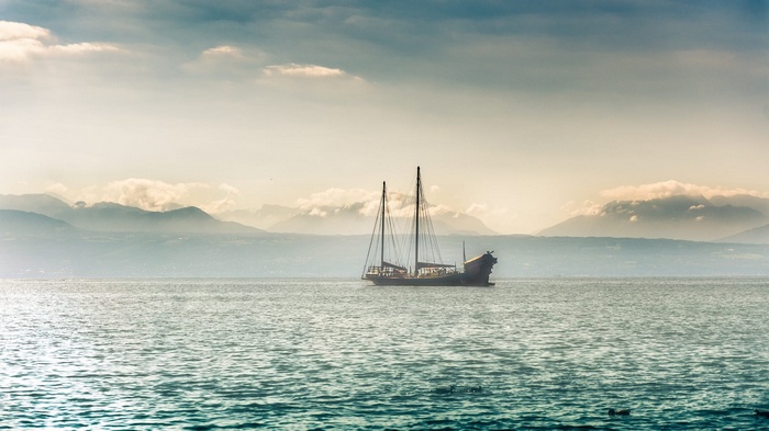Sailboat on a lake with mountains in the background