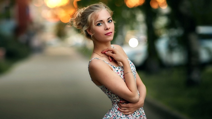 Woman in a floral dress posing outdoors