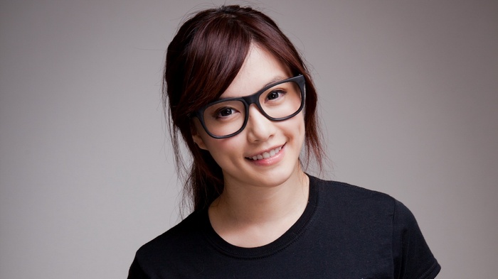Asian woman with glasses smiling