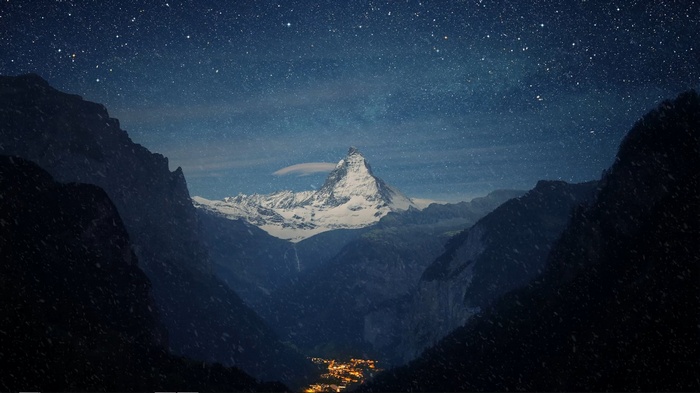 Snow-capped Matterhorn mountain under a starry night sky