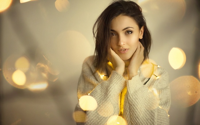 Woman with string lights around her neck