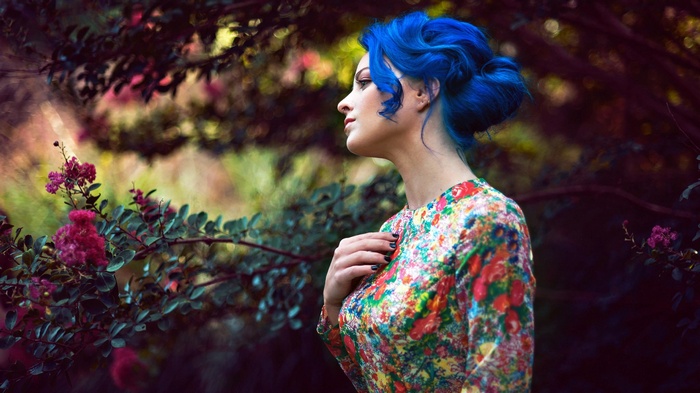 Woman with blue hair in a floral dress