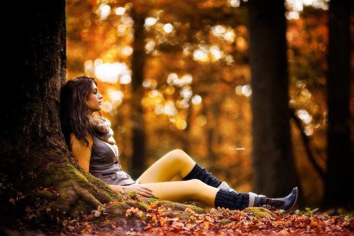 Woman in forest with auburn hair and wavy hair