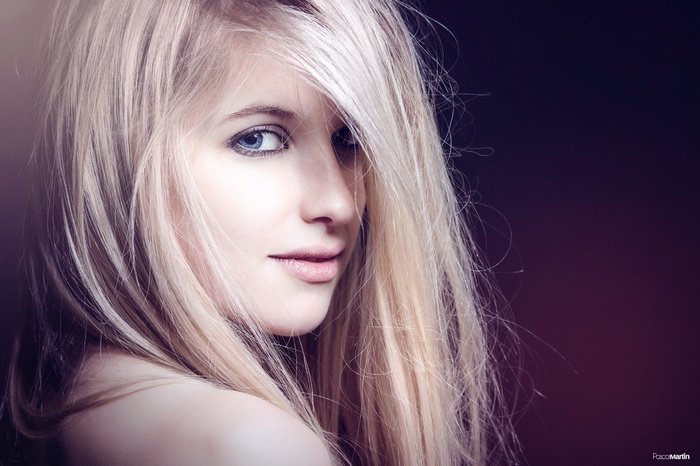 Blonde woman with blue eyes and bare shoulders