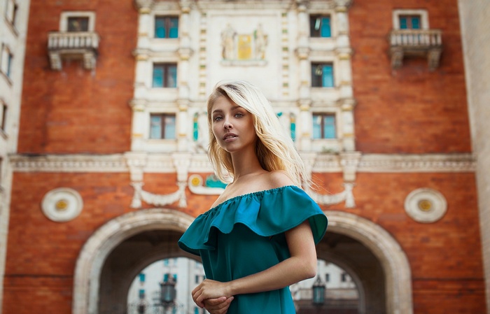 Woman with blonde hair in a teal dress