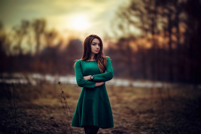 Woman in green dress outdoors at sunset