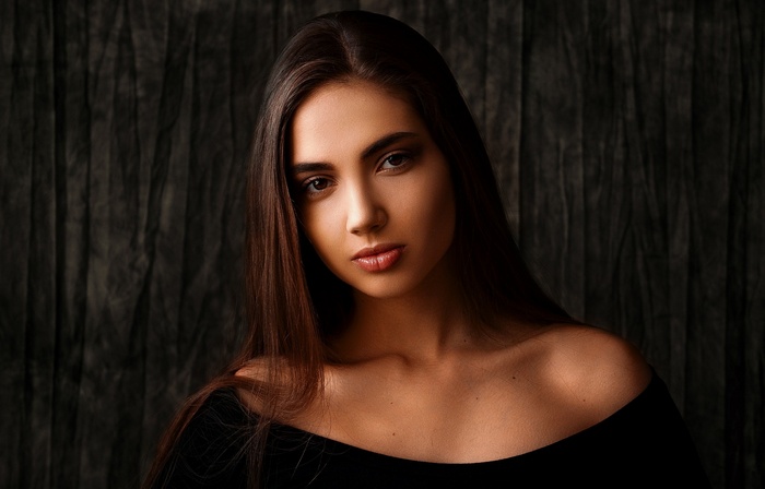 Woman with long brown hair in a black top