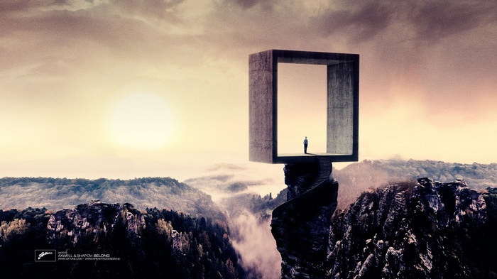 Man standing in concrete frame overlooking mountains