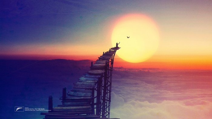 A person on a wooden bridge reaching for the sun