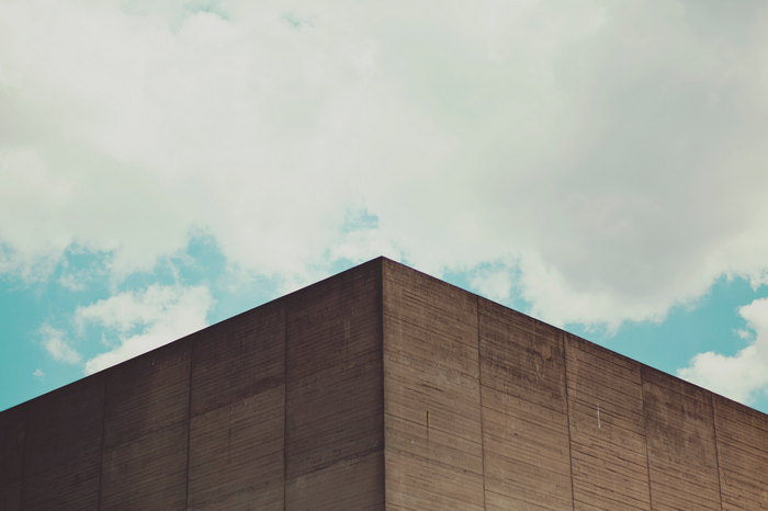 Minimalist concrete building corner against sky