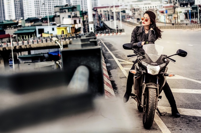 Woman in leather jacket on a Honda motorcycle