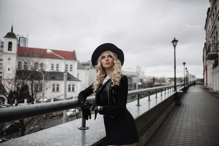 Woman in black hat and jacket outdoors