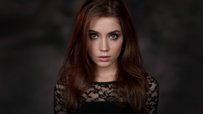 Woman with auburn hair and brown eyes looking at viewer