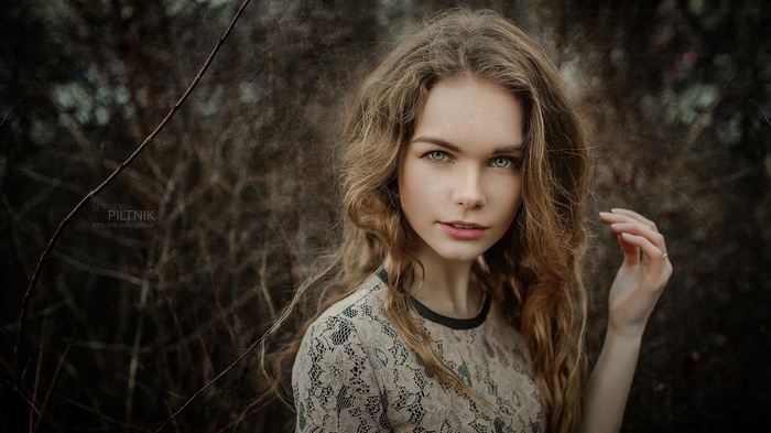 Woman with curly blonde hair outdoors