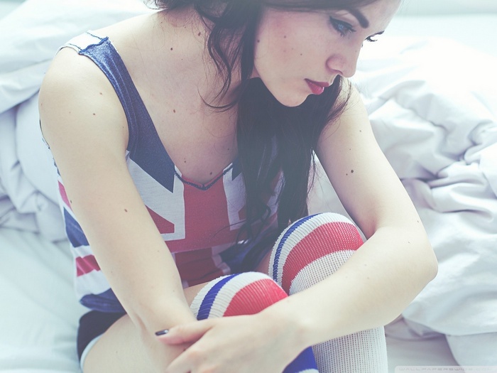 Woman in Union Jack tank top and striped socks