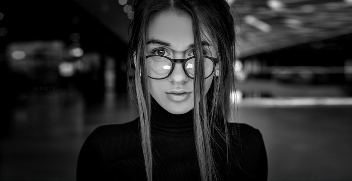 Woman with glasses wearing a black turtleneck