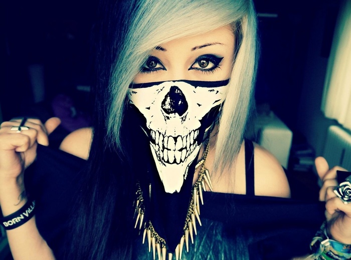 Woman with skull mask and spiked necklace