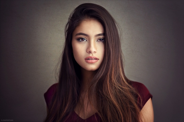Portrait of a young woman with long brown hair