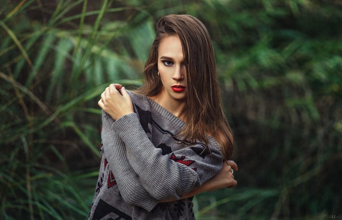 Woman in a sweater in a forest