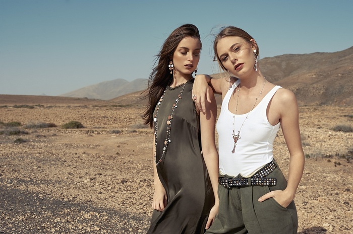 Two women posing in a desert landscape