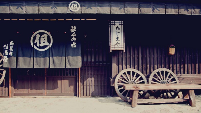 Traditional Japanese building with wooden wheels and bench