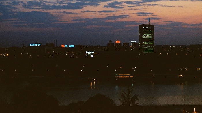 Cityscape at dusk with Samsung sign and moon