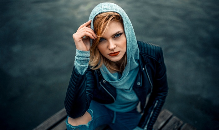 Woman in hoodie and leather jacket