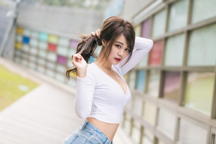 Sun Hui Tong with hands in hair outdoors