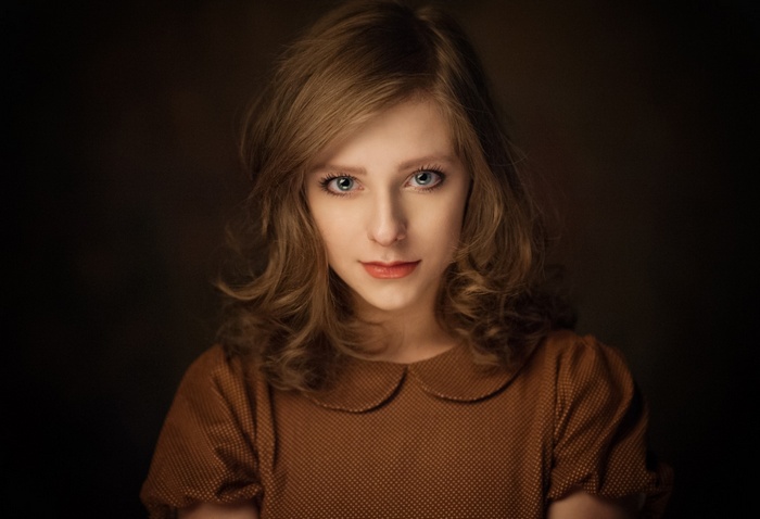 Portrait of a young woman with blue eyes and brown hair