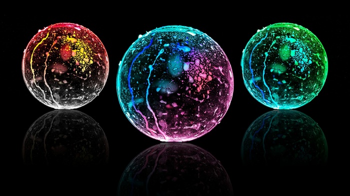Three colorful glowing spheres with reflections