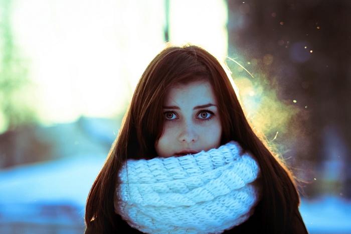 Young woman with brown hair and white scarf