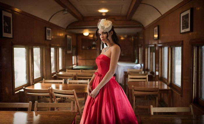Woman in red dress inside a train car