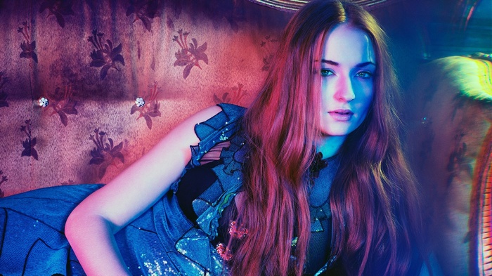 Sophie Turner with long red hair lying down