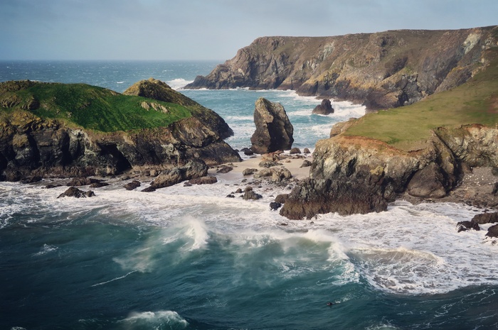 Rocky coastline with waves crashing on a beach