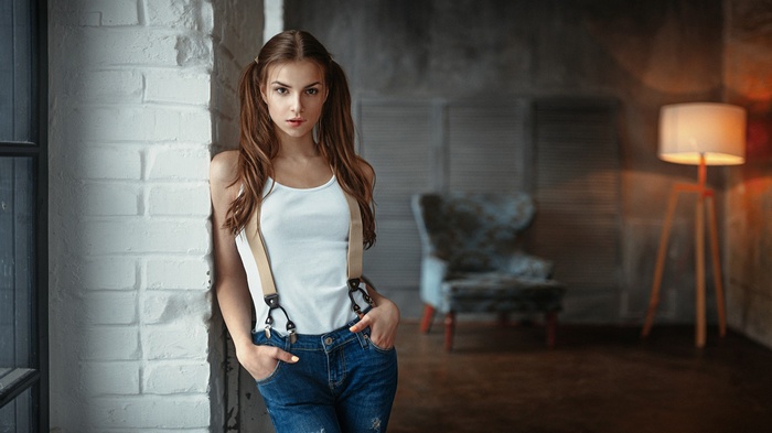 Woman with pigtails wearing suspenders and jeans