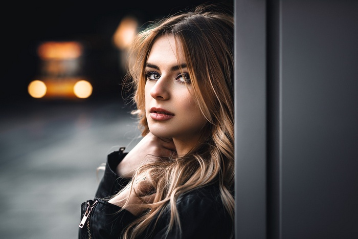 Woman in leather jacket looking at viewer