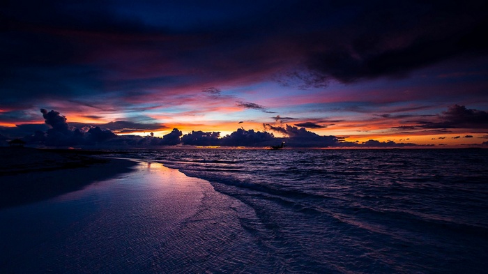 Sunset over the ocean with a beach