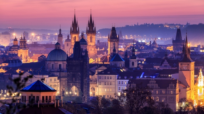 Prague cityscape at dusk with historic architecture and city lights
