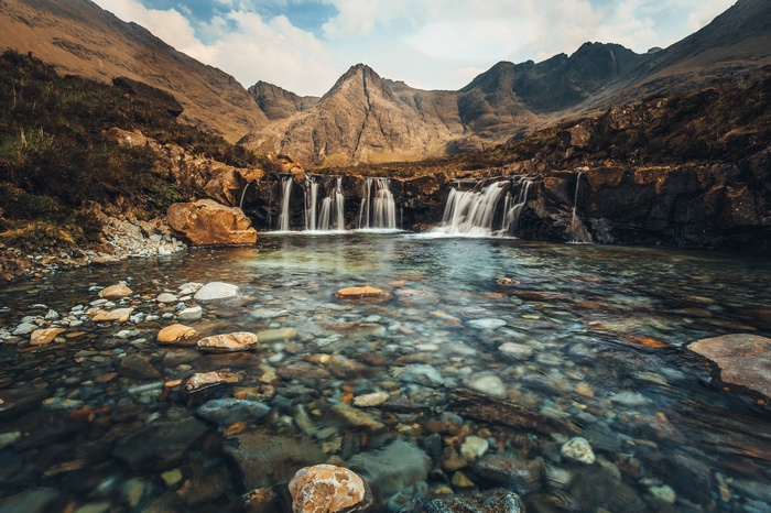 The Fairy Pools waterfall in Scotland with mountains