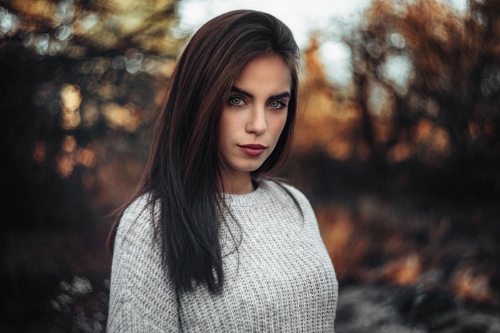 Portrait of a woman with dark hair and a grey sweater